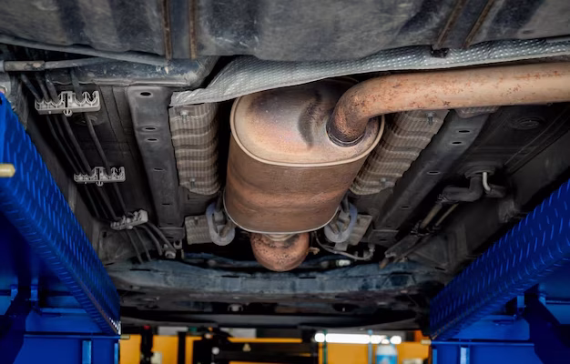 bottom-view-exhaust-pipe-car-while-lifted-vehicle-checkup-maintenance-service-part-metal-exhaust-muffler-pipe-with-rust-stains-garage-repair-fix-automotive-workshop_36367-10025
