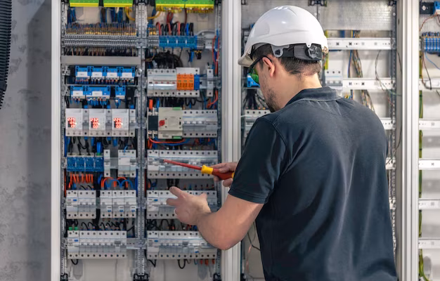 male-electrician-works-switchboard-using-electrical-connection-cable_169016-53666
